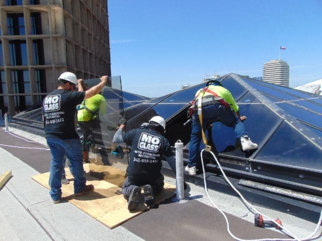 Mo Glass crew installing a glass skylight on a rooftop